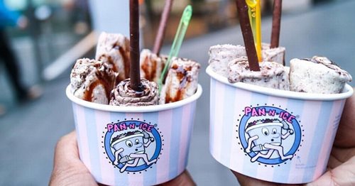 Two pots of Pan n ice, ice cream rolls with plastic spoons in them.