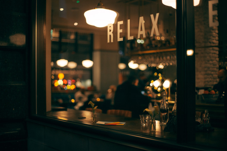 Outside of a restaurant in Farringdon with the word Relax on the glass.