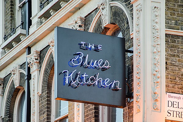 Blues kitchen restaurant sign on the corner of a street in Camden.
