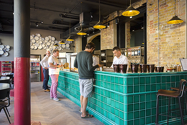 People queuing at the counter in Workspace® property China Works Fine & bone Café in Vauxhall.